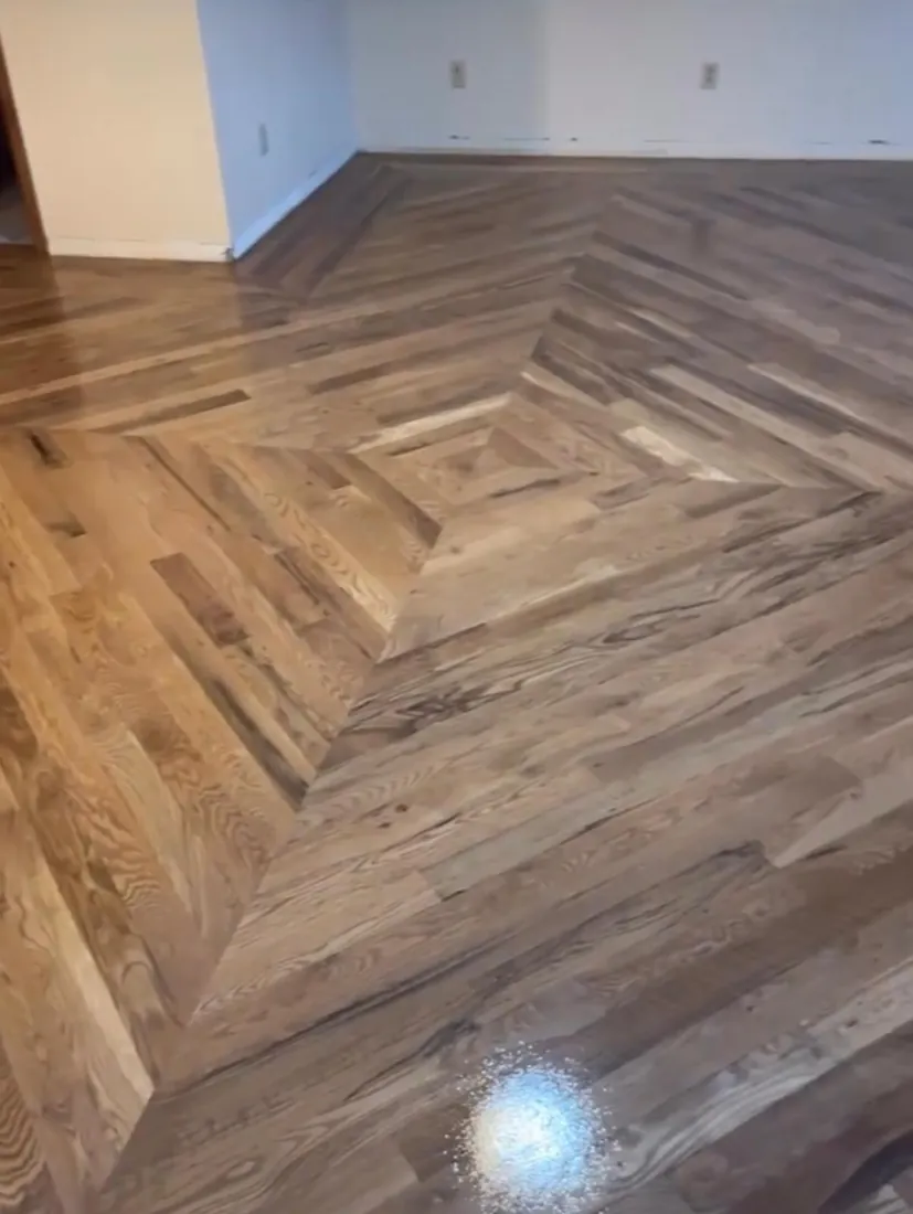 Herringbone floor with a diamond medallion set into the center of the room