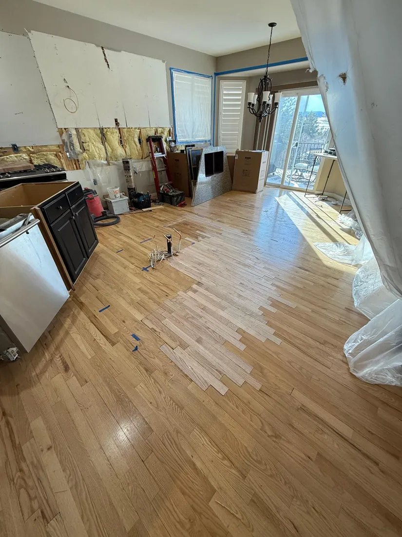 White oak planks going down across a kitchen floor mid installation