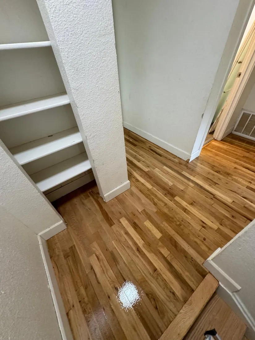 Entry floor refinished up to the base of a painted staircase