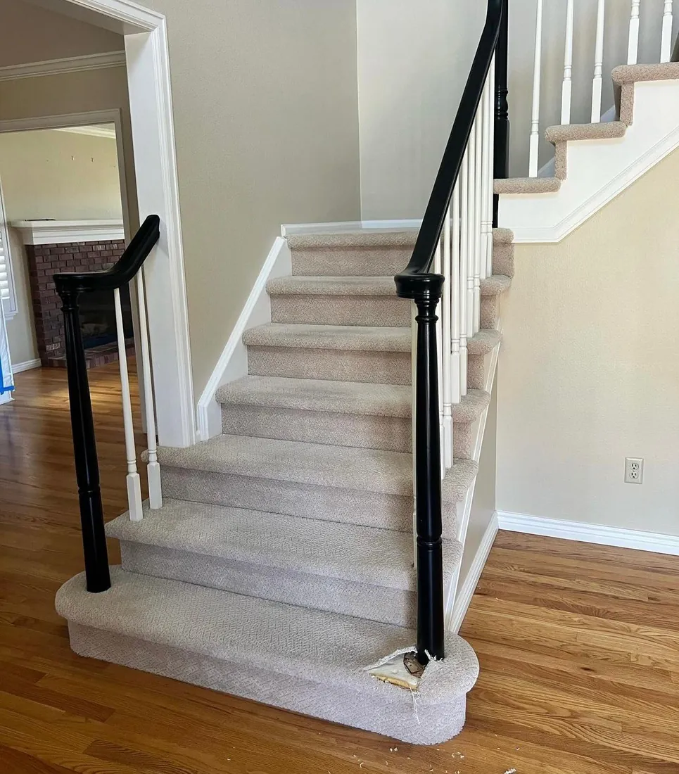 A staircase being converted from carpet to finished wood treads